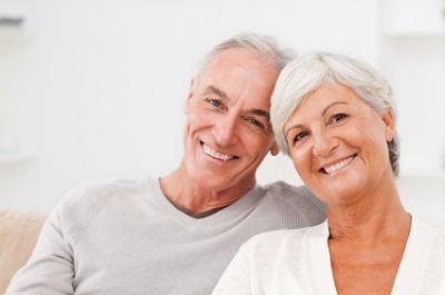 Couple sitting on couch at dentist office near me Webster Groves