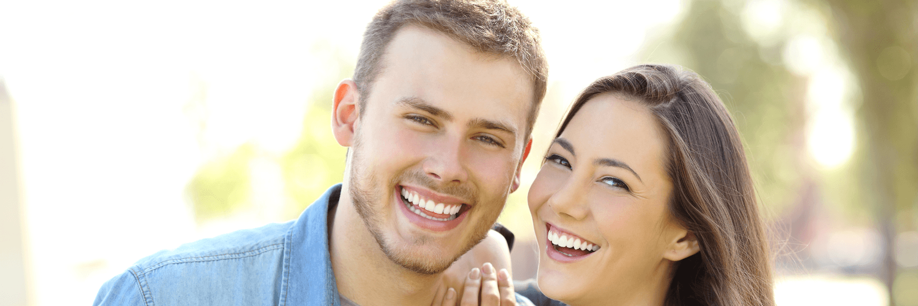 happy couple after dental implants in webster groves mo