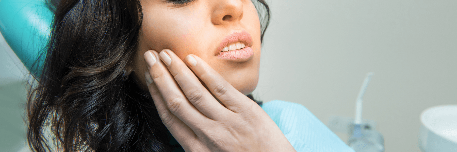 Woman rubbing jaw in pain, symbolizing bruxism issues, for Webster Groves Dental's blog on night gua