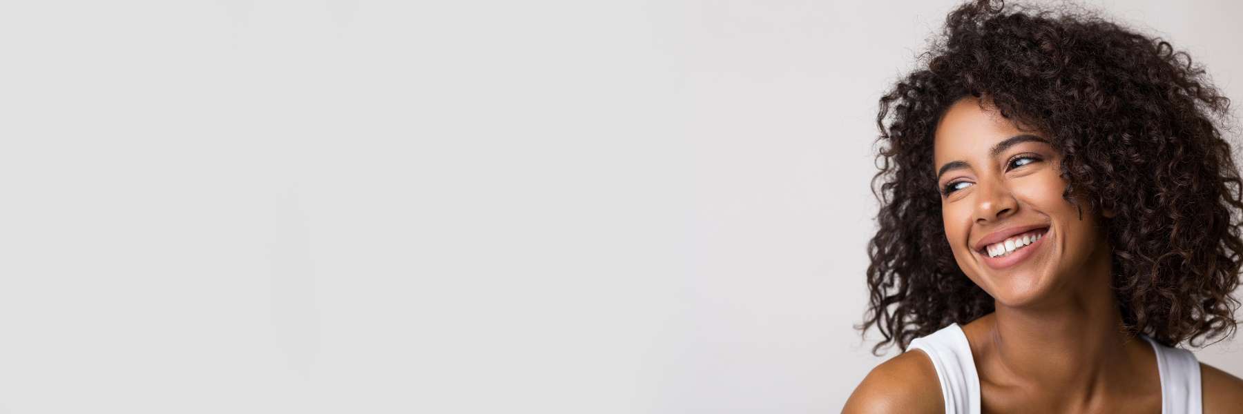 Woman with dental crowns smiling in Webster Groves, MO