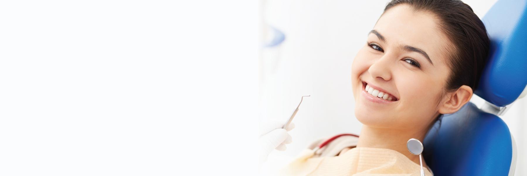 Patient smiling during treatment at safe dentist office in Webster Groves